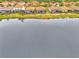 Aerial view of the property showing the location with a pond in the backyard and community at 9895 Wingood Dr, Venice, FL 34292