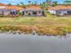 Home features a backyard oasis with screened-in lanai, pool, and lush greenery for privacy at 9895 Wingood Dr, Venice, FL 34292