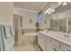 Bright primary bathroom featuring a glass enclosed shower, soaking tub, double sinks at 9895 Wingood Dr, Venice, FL 34292