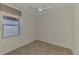 Neutral bedroom with a tile floor, a ceiling fan, and a large window that lets in natural light at 9895 Wingood Dr, Venice, FL 34292
