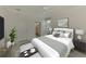 Bright bedroom with a ceiling fan, neutral color palette, and ensuite bathroom at 9895 Wingood Dr, Venice, FL 34292