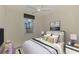 Bedroom featuring a ceiling fan, water view, tile floors, and ensuite bathroom at 9895 Wingood Dr, Venice, FL 34292