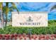Elegant stone sign for Watercrest community with manicured landscaping and a welcoming feel at 9895 Wingood Dr, Venice, FL 34292