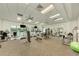 Community gym with various machines and weights, natural light, and ceiling fans at 9895 Wingood Dr, Venice, FL 34292