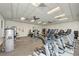 Well-lit gym featuring modern equipment, mirrored walls, and a spacious workout area at 9895 Wingood Dr, Venice, FL 34292