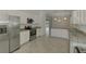 Bright open-concept kitchen featuring stainless steel appliances and granite countertops at 9895 Wingood Dr, Venice, FL 34292