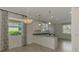 Bright kitchen and dining area featuring granite countertops and tiled floors at 9895 Wingood Dr, Venice, FL 34292