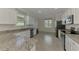 Bright kitchen featuring stainless steel appliances, granite countertops, and tiled floors at 9895 Wingood Dr, Venice, FL 34292