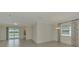 Open concept living room seamlessly connects the living area, dining space, and offers great views of the lake at 9895 Wingood Dr, Venice, FL 34292