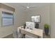 Bright home office with neutral tones, modern desk, decor, and a ceiling fan at 9895 Wingood Dr, Venice, FL 34292