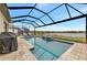 Sparkling screened-in pool overlooking a serene lake, complete with lounge chairs for relaxing and enjoying the view at 9895 Wingood Dr, Venice, FL 34292