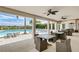 Community pool with ample seating and covered outdoor dining area with ceiling fans at 9895 Wingood Dr, Venice, FL 34292