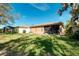Expansive backyard showcasing a well-maintained lawn and lush landscaping at 107 Corte Del Rosa, Venice, FL 34285