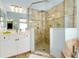 Elegant bathroom featuring glass shower and modern vanity at 107 Corte Del Rosa, Venice, FL 34285