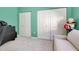 Bedroom with green walls and two closets at 107 Corte Del Rosa, Venice, FL 34285