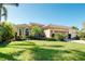 Beautiful single-story home featuring a well-manicured lawn and a two-car garage at 107 Corte Del Rosa, Venice, FL 34285
