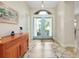 Bright foyer features tile flooring with decorative inlays and double doors at 107 Corte Del Rosa, Venice, FL 34285