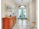 Bright foyer features tile flooring with decorative inlays and double doors at 107 Corte Del Rosa, Venice, FL 34285