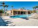 Community pool area with lounge chairs and beautiful landscaping at 107 Corte Del Rosa, Venice, FL 34285