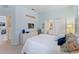 Bright bedroom featuring neutral colors, carpet, and easy access to the en suite bathroom at 11053 Barnsley Dr, Venice, FL 34293