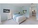 Serene primary bedroom showcasing a plush bed, cozy carpet, and a convenient ensuite bathroom at 11053 Barnsley Dr, Venice, FL 34293