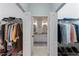 Spacious walk-in closet with custom shelving and dual access to a luxurious Primary bathroom at 11053 Barnsley Dr, Venice, FL 34293