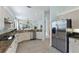 Open concept kitchen with stainless steel appliances and a large counter that offers ample workspace at 11053 Barnsley Dr, Venice, FL 34293