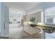 Bright kitchen with granite counters, stainless sink, white cabinets, and modern appliances at 11053 Barnsley Dr, Venice, FL 34293