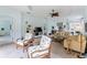 Airy living space with tile flooring, light blue walls, and comfortable seating arrangements at 11053 Barnsley Dr, Venice, FL 34293