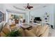 Bright living area showcases tile flooring, light blue walls, ceiling fan, and built-in shelving at 11053 Barnsley Dr, Venice, FL 34293
