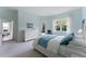 Bright main bedroom with walk-out access and complemented by natural light from the large window overlooking tropical greenery at 11053 Barnsley Dr, Venice, FL 34293