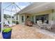 Expansive screened-in patio with seating area, dining set, and lush landscaping at 11053 Barnsley Dr, Venice, FL 34293