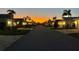 Peaceful street view at sunset showcases the neighborhood's well-maintained homes and mature palm trees at 11053 Barnsley Dr, Venice, FL 34293