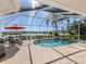 Inviting screened-in pool area with a spa, waterfront views, and outdoor seating at 1374 Brenner Park Dr, Venice, FL 34292