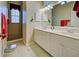 Bathroom features a dual vanity and tiled walk-in shower at 1655 Lancashire Dr # 1655, Venice, FL 34293
