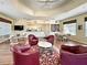 Inviting common area with comfortable seating, tables, television, and access to a kitchenette at 1655 Lancashire Dr # 1655, Venice, FL 34293