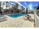 Community pool area with seating and well-maintained landscaping offering a relaxing environment at 1655 Lancashire Dr # 1655, Venice, FL 34293