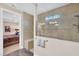 Beautifully tiled shower with glass enclosure and unique window detail at 18987 Formosa St, Venice, FL 34293