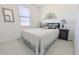 Clean and modern bedroom features neutral walls, soft decor and a comfortable bed at 19716 Fishhawk Trl, Venice, FL 34293