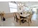 Bright dining room featuring modern lighting and a spacious table for Gathering gatherings and entertaining at 19716 Fishhawk Trl, Venice, FL 34293