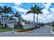 Community entrance sign for Tortuga, a Wellen Park neighborhood, with palm trees and lush landscaping at 19716 Fishhawk Trl, Venice, FL 34293
