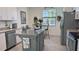 Charming kitchen with an island, stainless steel appliances, and eat-in breakfast nook at 19716 Fishhawk Trl, Venice, FL 34293