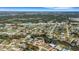 Expansive aerial view of a residential area featuring a home with a backyard bordering a canal and beautiful landscaping at 1985 Fairview Dr, Englewood, FL 34223