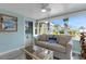Cozy sunroom with comfortable seating and tropical views creates a serene escape at 1985 Fairview Dr, Englewood, FL 34223
