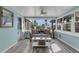 Bright sunroom with a comfortable couch, coastal accents, and plentiful natural light at 1985 Fairview Dr, Englewood, FL 34223