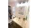 Bright bathroom featuring a vanity with a sink, toilet, decorative shower curtain and a framed mirror at 28 Castaway Ct, North Port, FL 34287