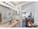 Bright bathroom featuring a view into the bedroom, wallpaper and neutral countertop at 3300 Loveland Blvd # 1504, Punta Gorda, FL 33980