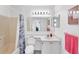 Clean bathroom featuring a toilet, a sink with a vanity, and a shower and tub with colorful shower curtain at 3300 Loveland Blvd # 1504, Punta Gorda, FL 33980