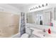 Bathroom featuring a vanity and sink, toilet, and shower over tub with an updated shower curtain at 3300 Loveland Blvd # 1504, Punta Gorda, FL 33980
