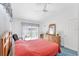 Comfortable bedroom featuring a bed and view of the backyard at 3300 Loveland Blvd # 1504, Punta Gorda, FL 33980